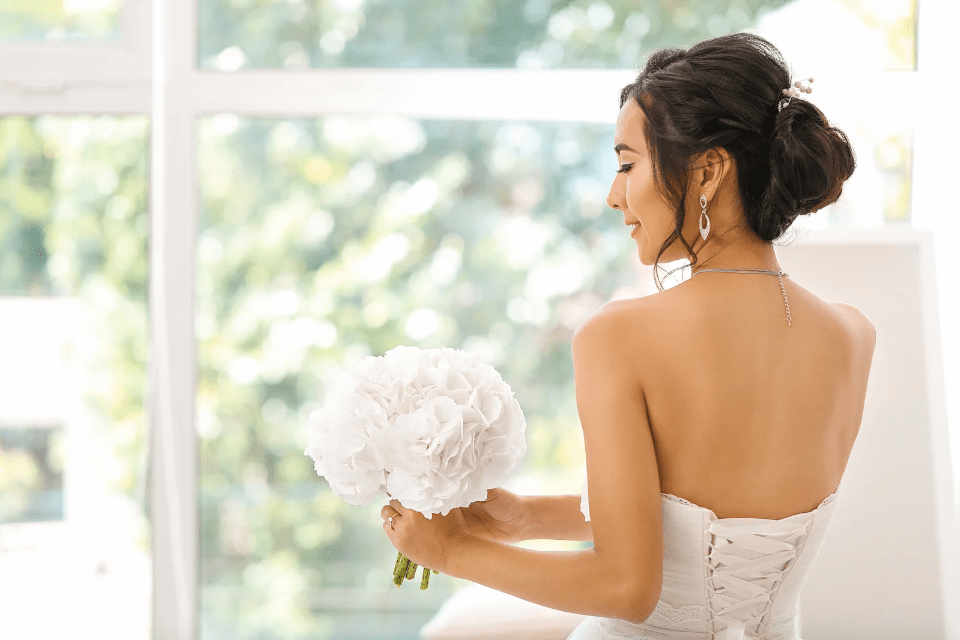 Back View of a Bride in White Near the Window on Blossoms Dating 22 Reasons to Join - Blossoms Dating Blog