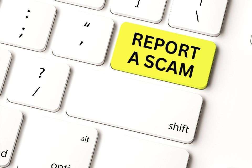 Keyboard with Report a Scam Button - How Do You Report a Scam - How to Spot a Filipina Scammer - Blossoms Dating Blog