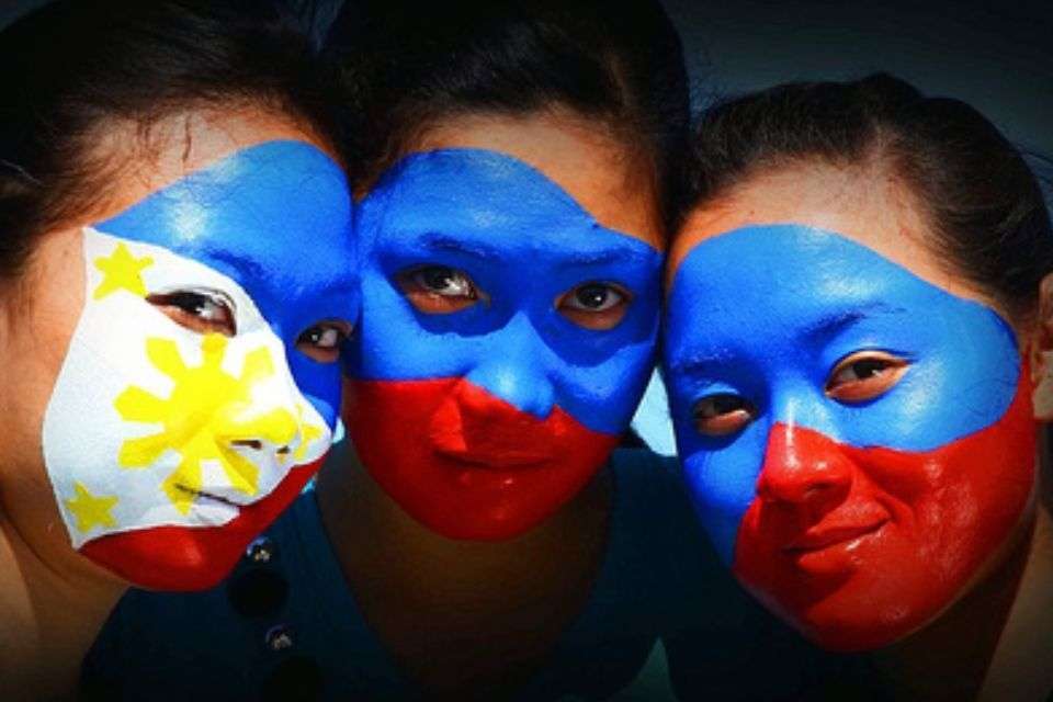 Image of Three Filipina Girls with the Philippine Flag Painted on Their Faces - What Does Pinay Mean - Blossoms Dating Blog