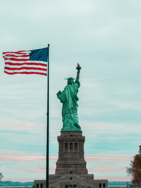 Statue of Liberty with an American Flag