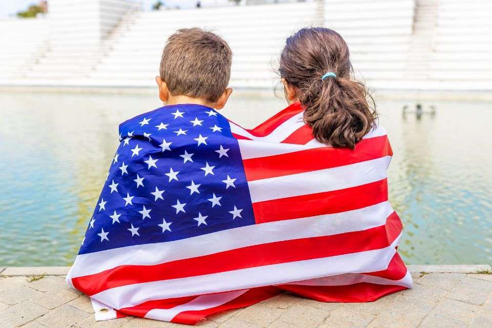 Two Children Wrapped in the American Flag - How to Get My Filipina Girlfriend to the US - Blossoms Dating Blog