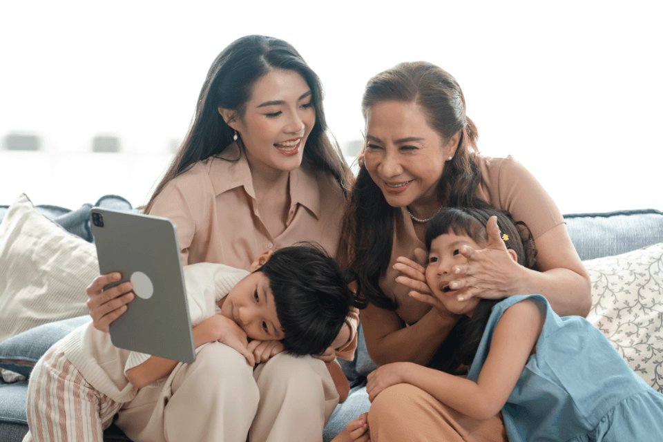 Happy Filipino Family with Grandmother Using a Tablet