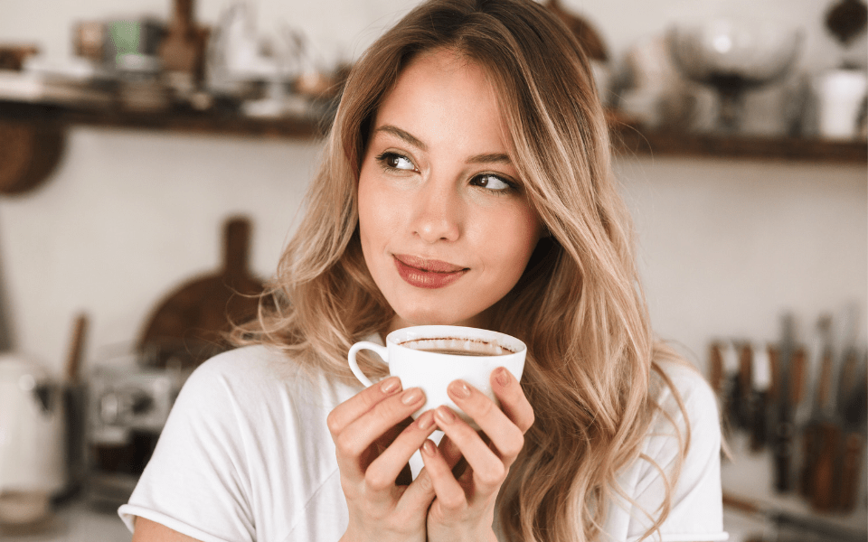 Modern Filipino Woman Drinking Coffee in Her Kitchen