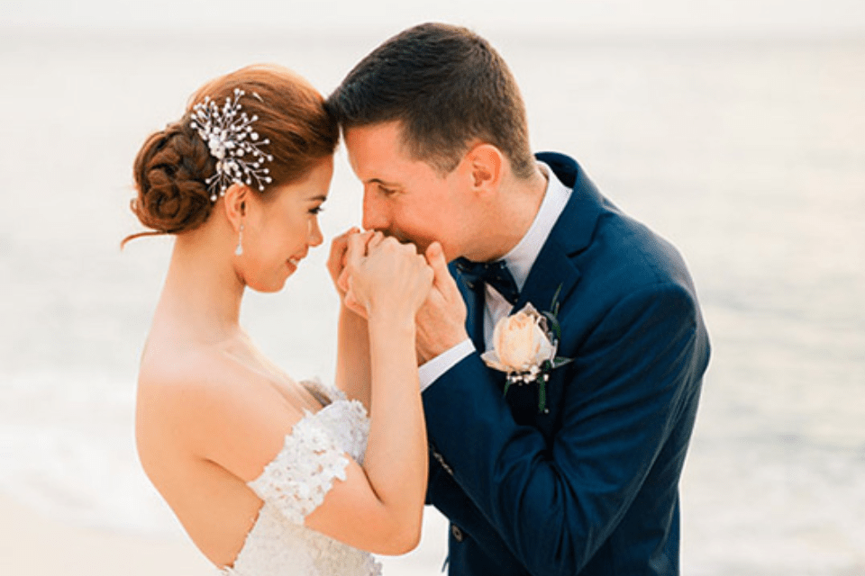 American Groom Kissing the Hands of His Filipina Bride