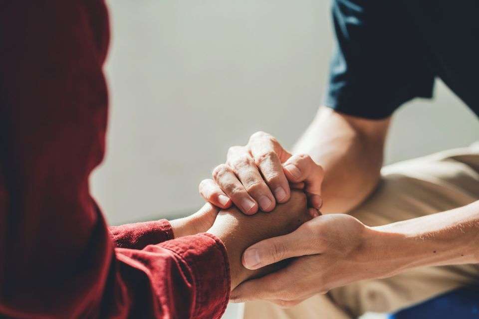 American Man Holding A Filipina Woman's Hands - How to Win the Heart of a Filipina A Guide for Men - Blossoms Dating Blog