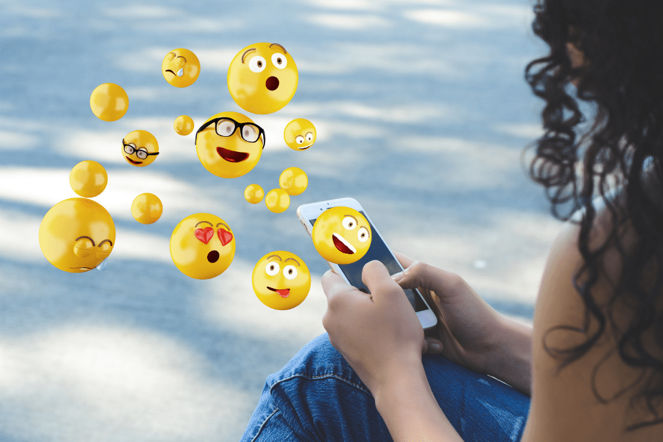 Filipina Using Smartphone and Sending Emojis