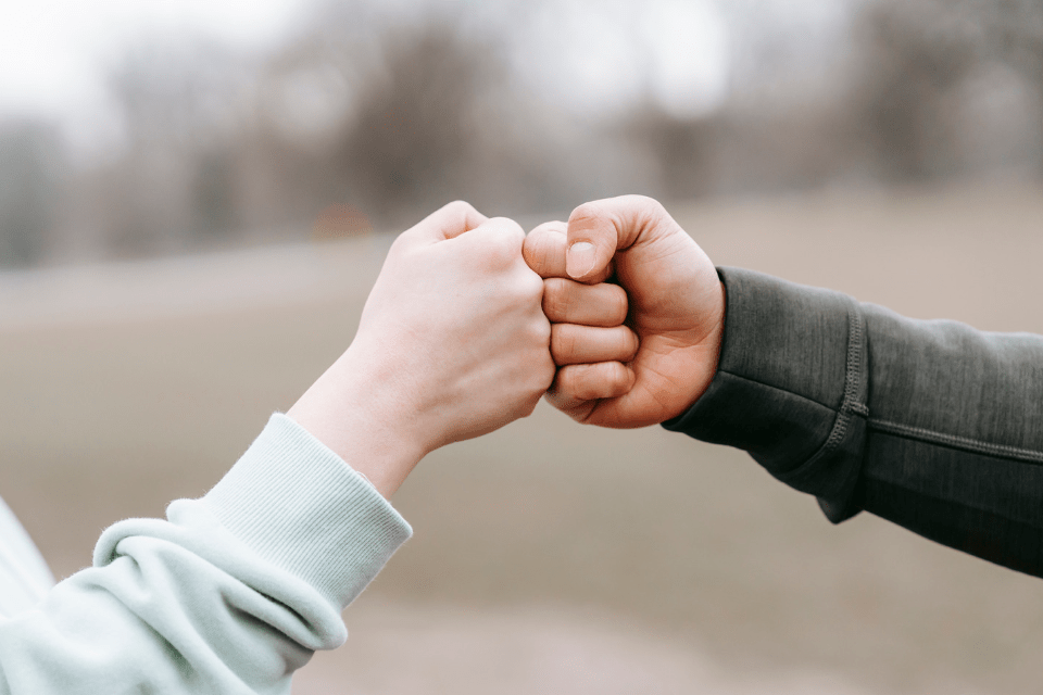 Man and Woman Giving Each Other a Fist Bump