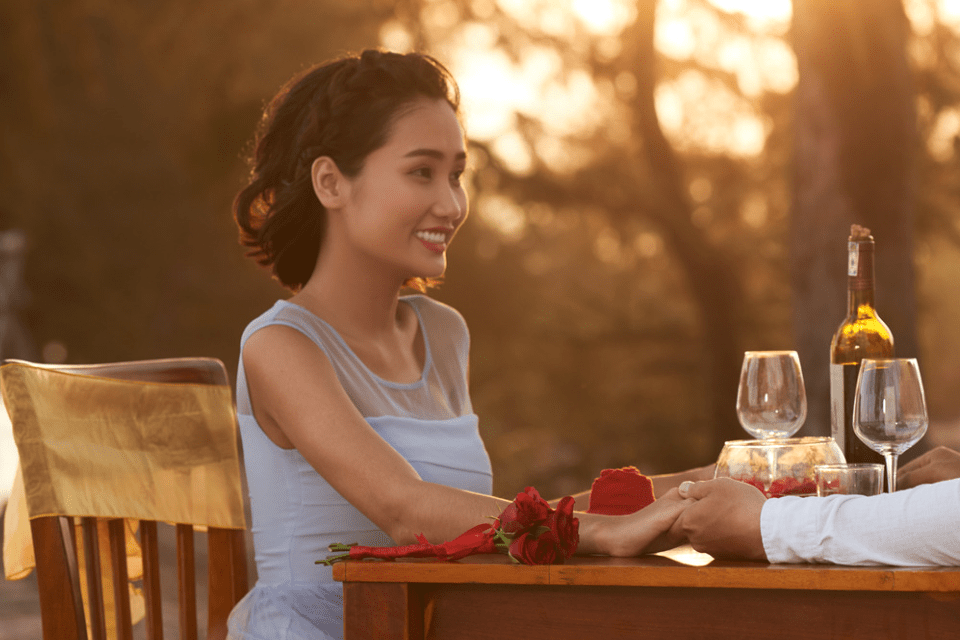 Filipina Half of an Interracial Couple Having a Romantic Dinner Outdoors
