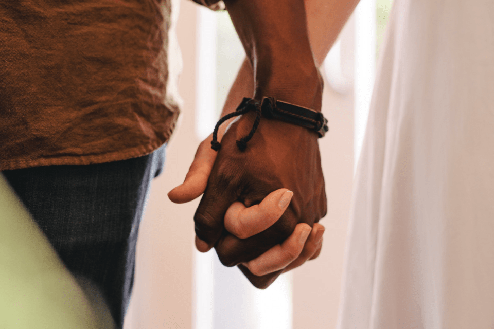 Interracial Dating Couple Holding Hands - Navigating the Challenges of Filipino-Foreigner Relationships - Blossoms Dating Blog