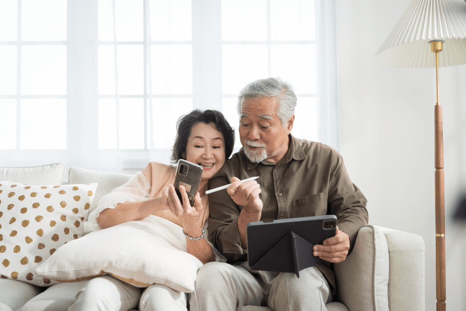 Senior Filipino Couple Using Phone and Tablet - Filipino Dating Culture - Insights into Dating Practices in the Philippines
