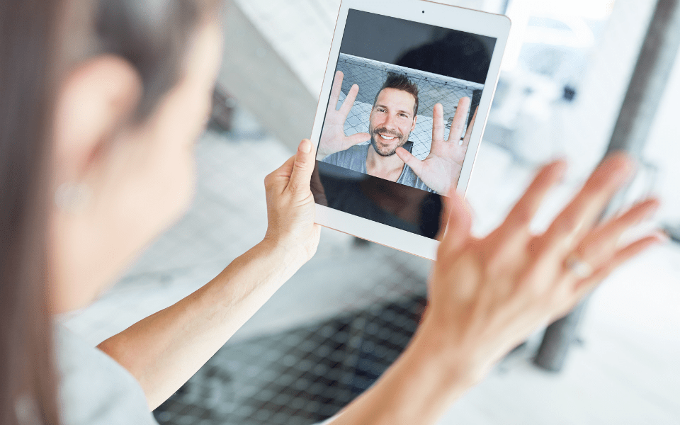 Long-Distance Couple Talking Via Video Chat - Simple Guide to Navigating Long-Distance Online Dating - Blossoms Dating Blog