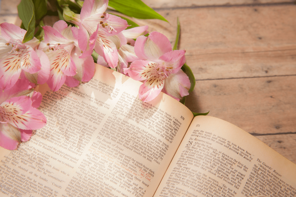 Alstromeria Flowers on an Open Bible Being Read by a Christian Filipino Woman