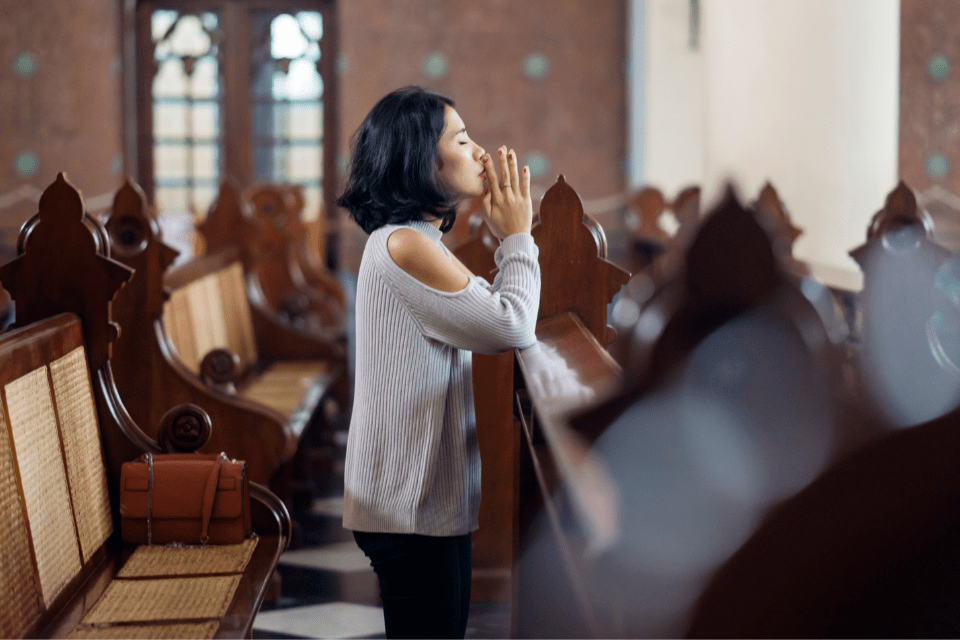 Beautiful Filipino Woman Praying a Catholic Church