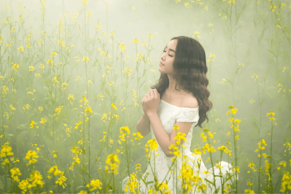 Young Christian Filipino Woman in a Field of Yellow Flowers