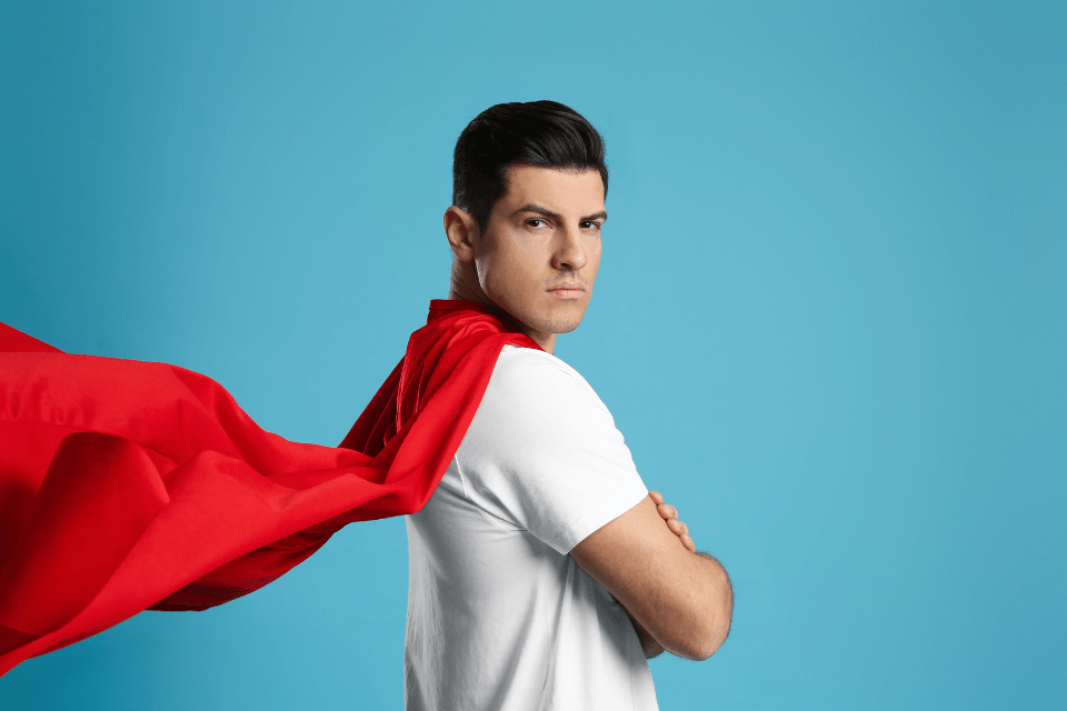 Man wearing a red cape with a vigilant heart to spot the red flags and protect against scams in financial requests in online relationships.